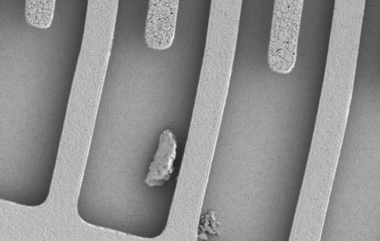 MEMS Device with Obstructing Particle