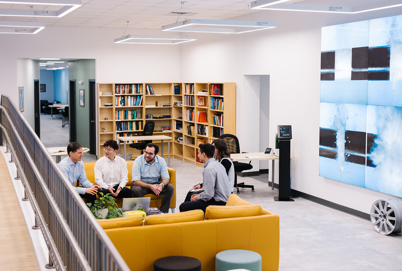 Veryst interior with employees and bookshelves